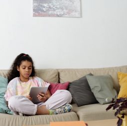 photo-of-girl-sitting-on-sofa-while-using-tablet-4144040