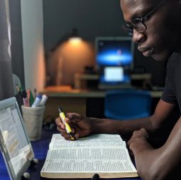 photo-of-man-reading-a-book-2574616